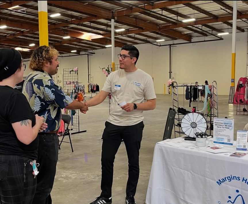 Edgar Avilez of Margins Health greeting community members at an outreach event